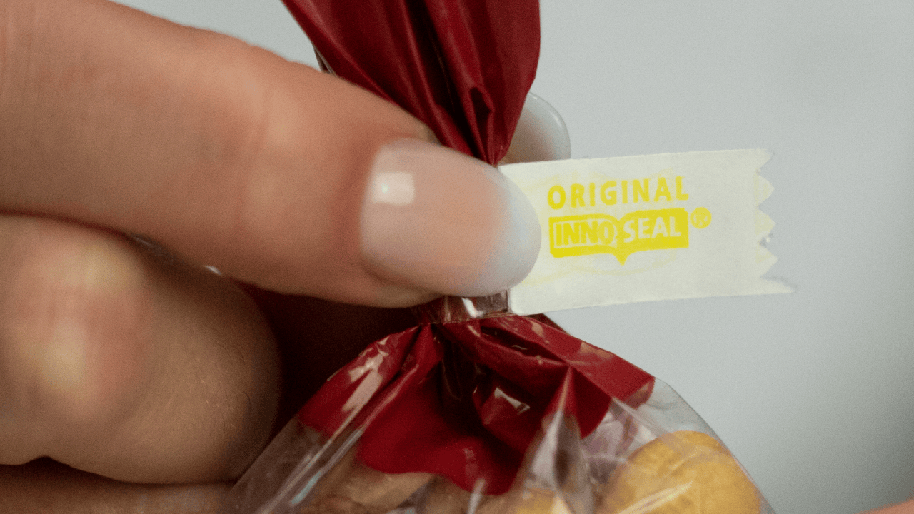 This is the Innoseal® seal. The paper adhered to the tape features our authentic brand, displaying the Original Innoseal® logo on the outside of the closure. This seal is created using the unique Innoseal® Sealer. (Shown with yellow refill paper).