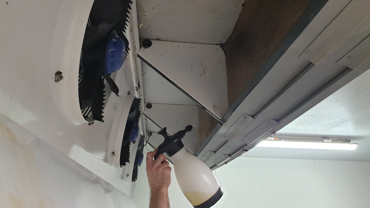 Spraying the cooling register with our NA-Cleaner