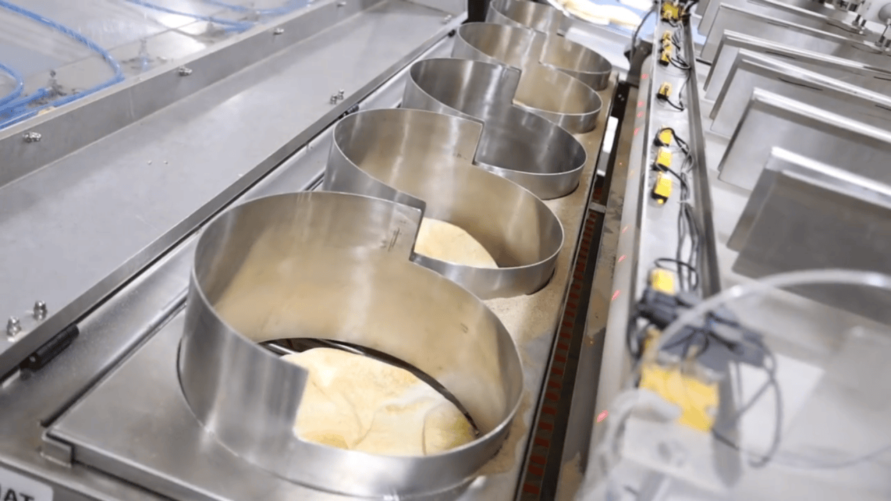 Precision in action – Farhat’s advanced system ensures perfect alignment and handling of freshly baked Lebanese pita bread for seamless production.