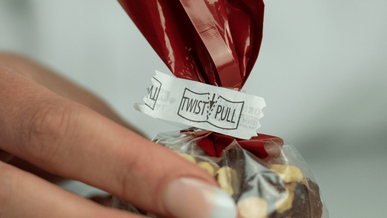 This is the Innoseal® seal showing the twist and pull instructions. The new, fresh seal remains intact, with no tear visible. Innoseal® Sealers provide a tamper-evident closure every time. A tear across the seal indicates the bag has been opened and the contents may have been tampered with. (Shown with black refill paper).