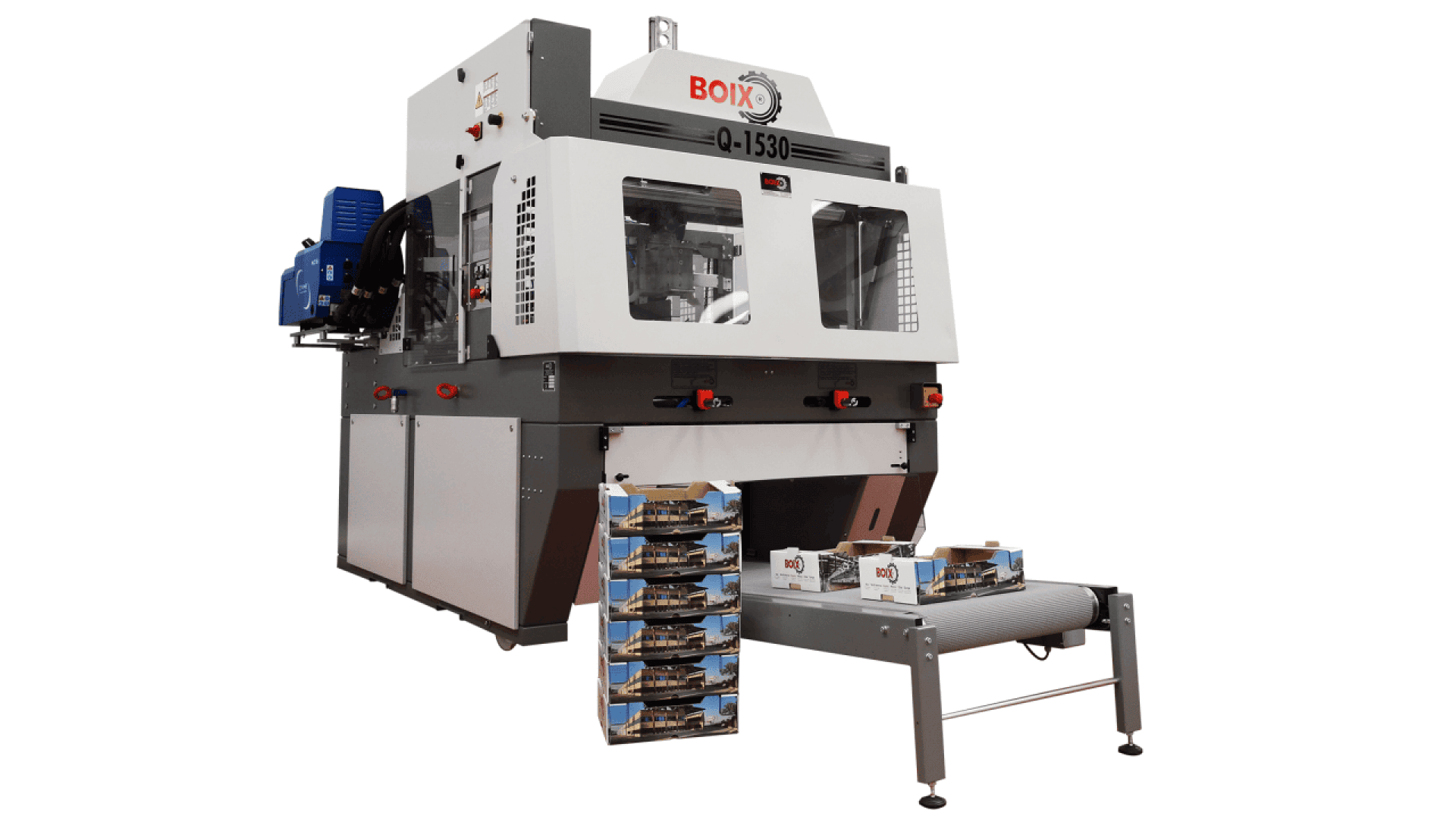 A large industrial Boix Q-1530 machine for packaging, with assembled cardboard boxes being dispensed onto a conveyor belt in front of the machine.