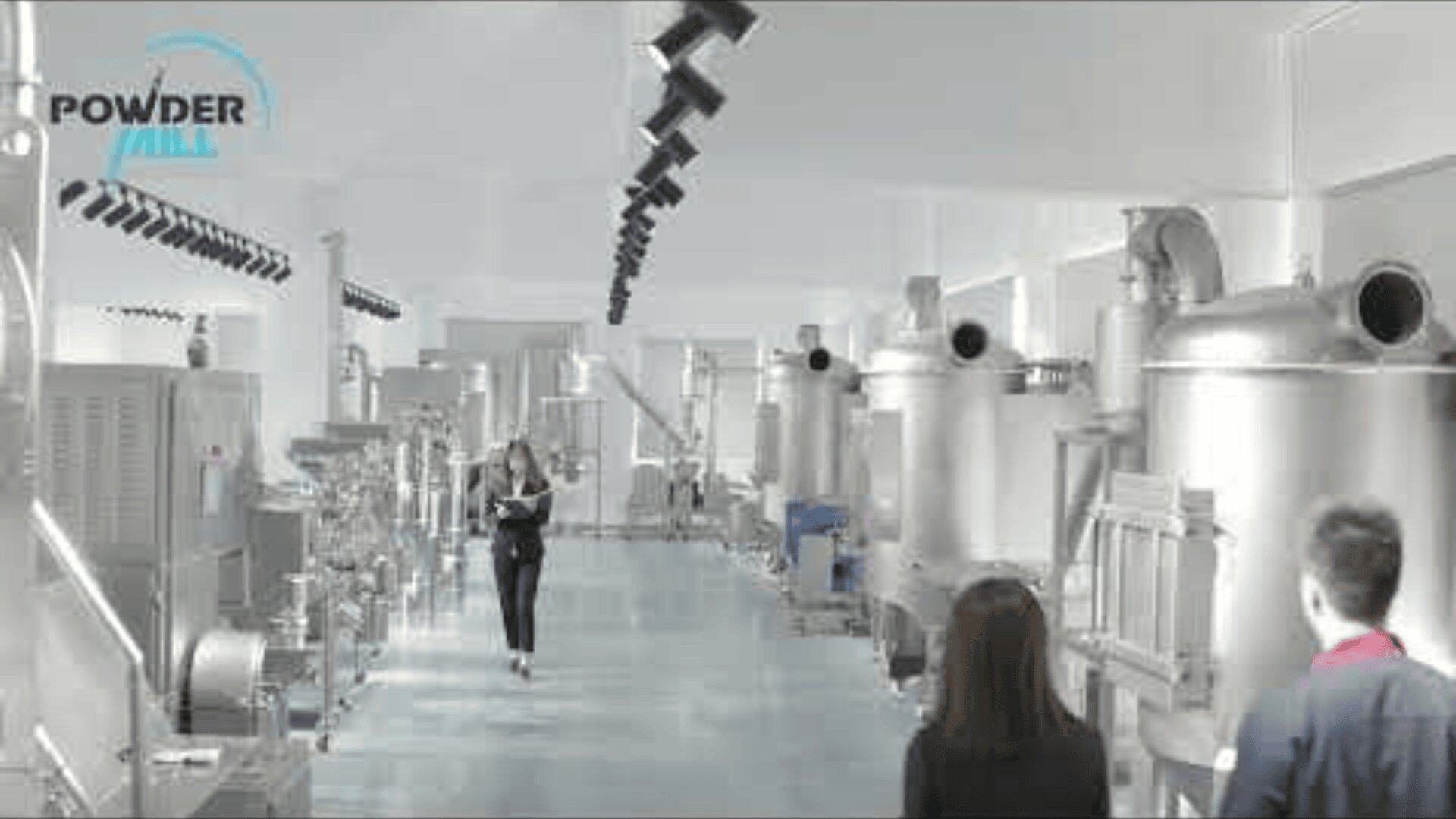 A modern industrial facility with various large stainless steel machines, two people in the foreground, and a person walking down the central aisle; POWDER logo is visible on the top left.