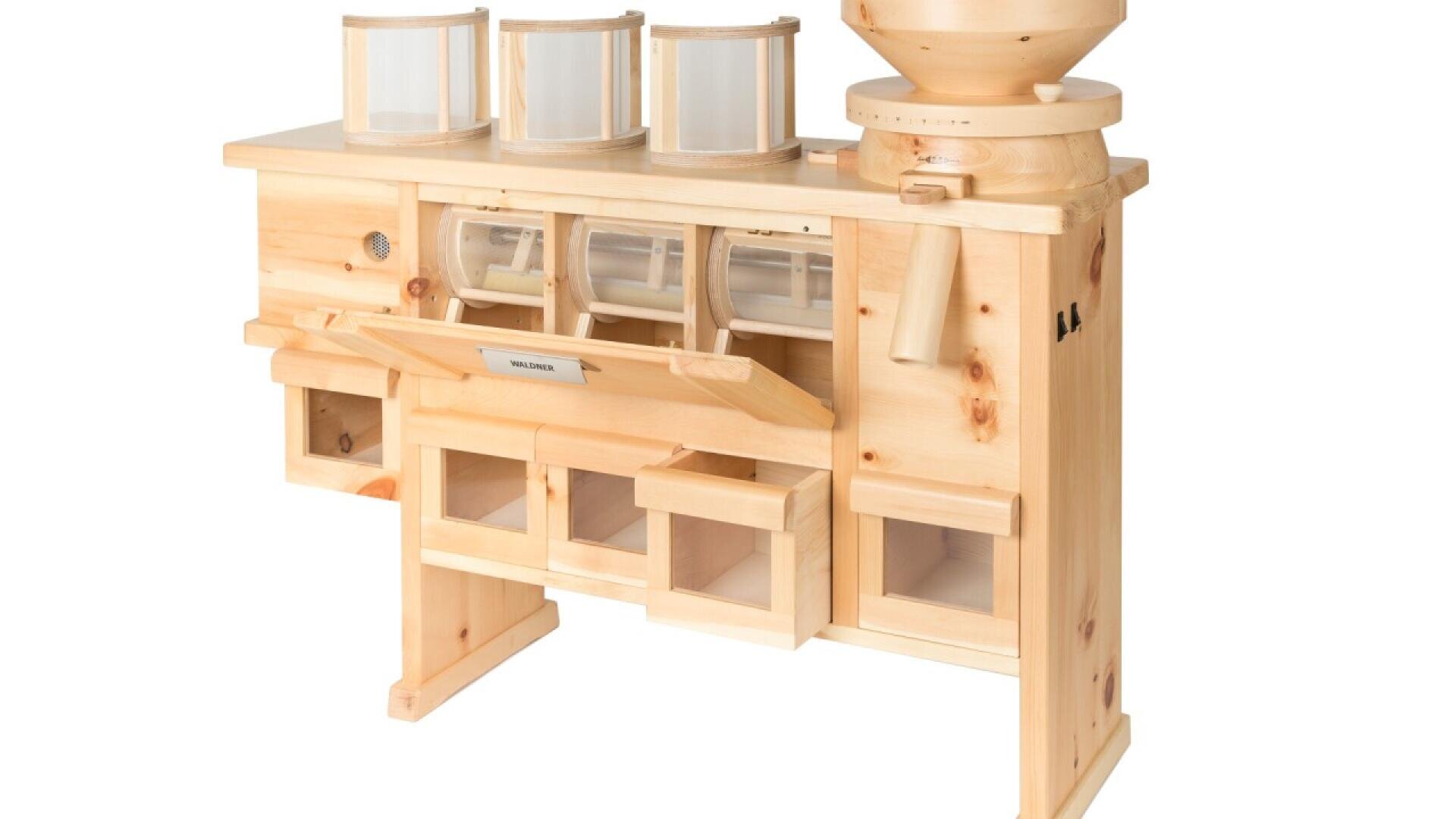A wooden grain mill with multiple clear canisters and compartments for sorting and storing ground flour, designed for efficient grain processing.