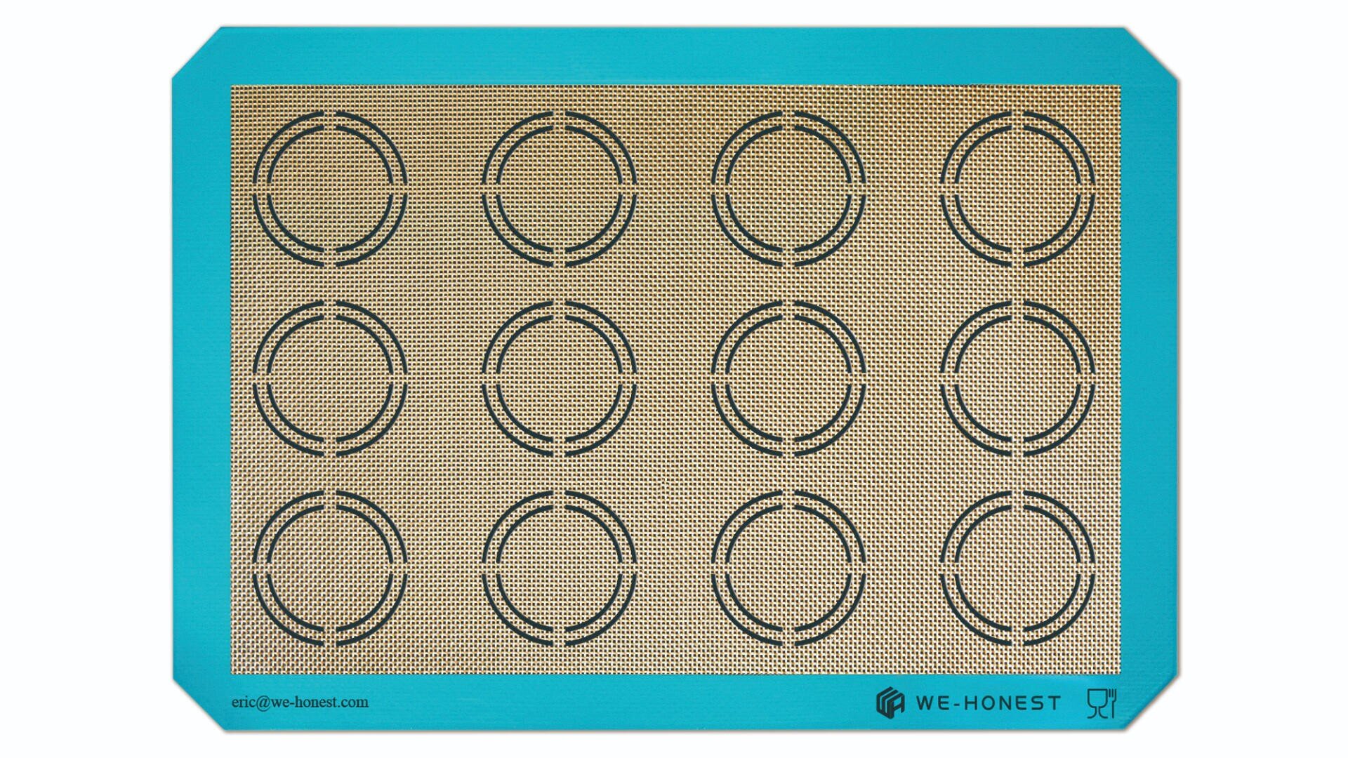 A rectangular silicone baking mat with a turquoise border and a grid of 15 black circles for even spacing, used for guiding cookie or macaron placement. The words WE-HONEST appear in the bottom right corner.