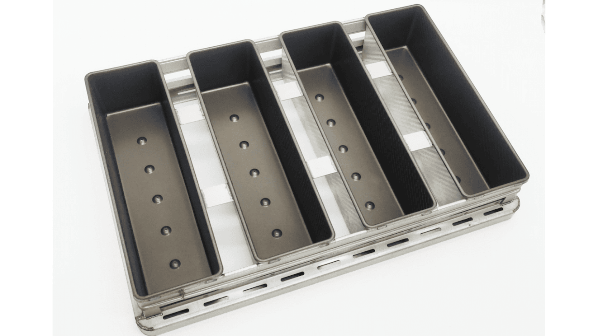 A metal tray with five rectangular, open-top compartments arranged side by side, each with evenly spaced holes in the bottom, likely used for grilling or smoking food.