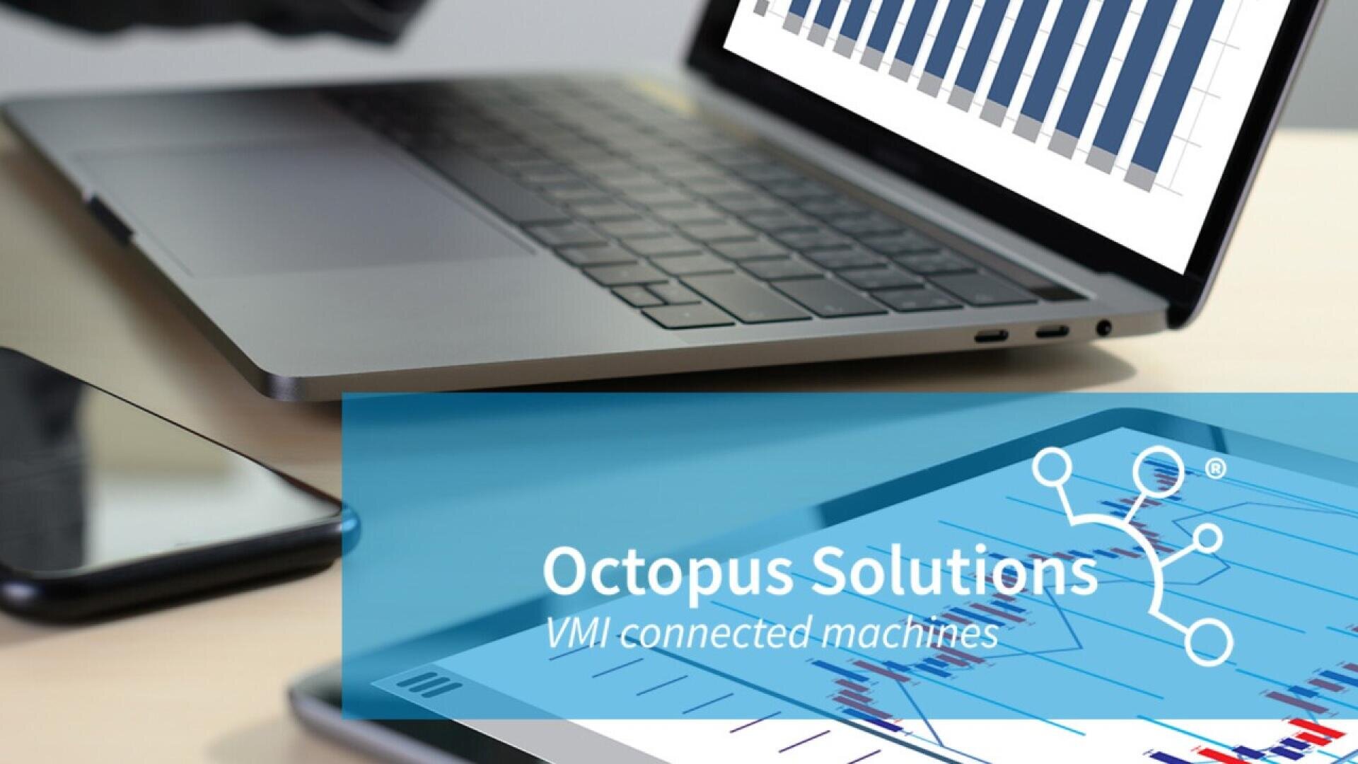 Auf einem Schreibtisch steht neben einem Smartphone ein Laptop mit einem Balkendiagramm. Im Vordergrund zeigt ein Tablet Datendiagramme mit dem Text „Octopus Solutions VMI connected machines“ und einem Netzwerklogo.